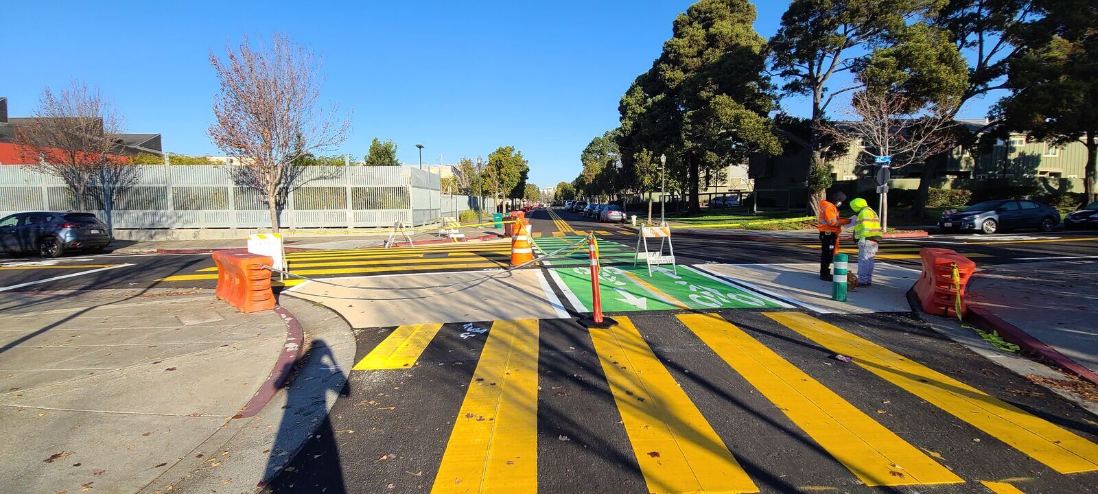A green bike box painted ahead of the stop line at an intersection