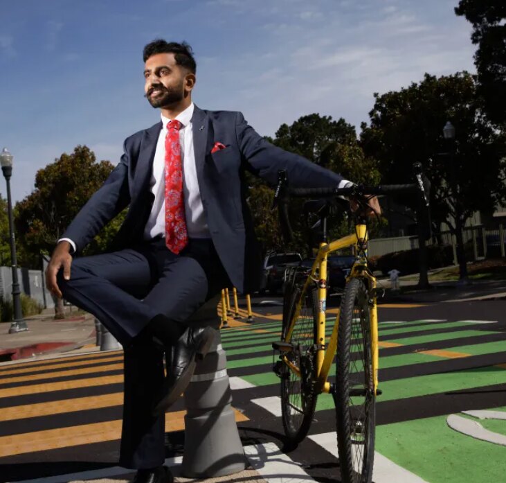 Vignesh Swaminathan in a suit beside a bike lane